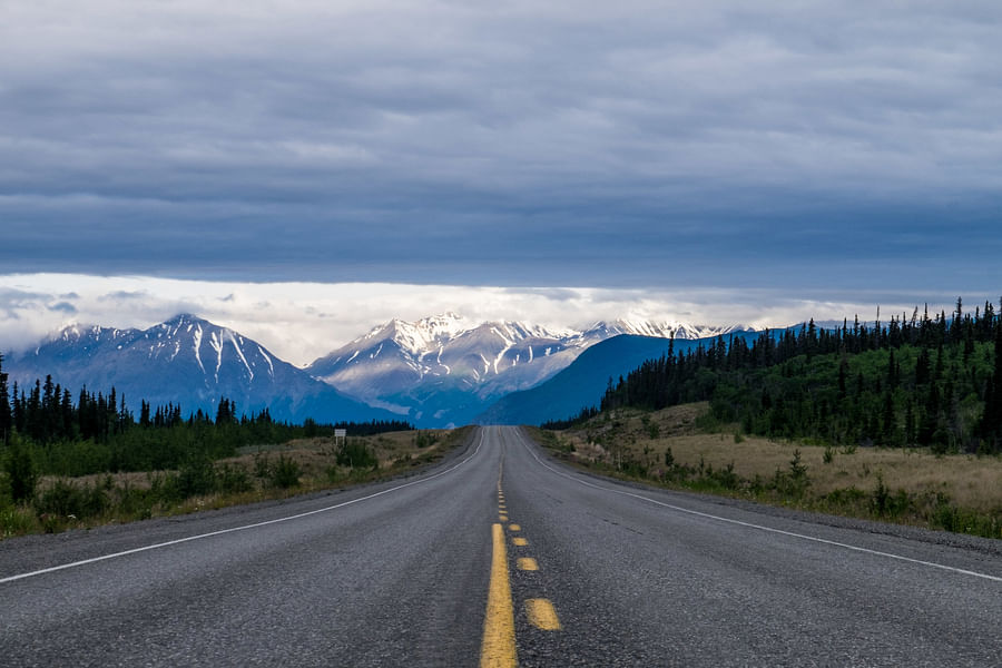 Scenic view of Alaskan highway with majestic mountains in the background