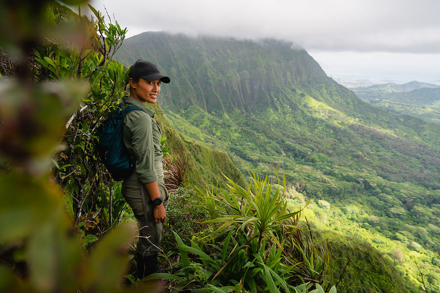 Backpacker ascending a Hawaiian trail at dawn